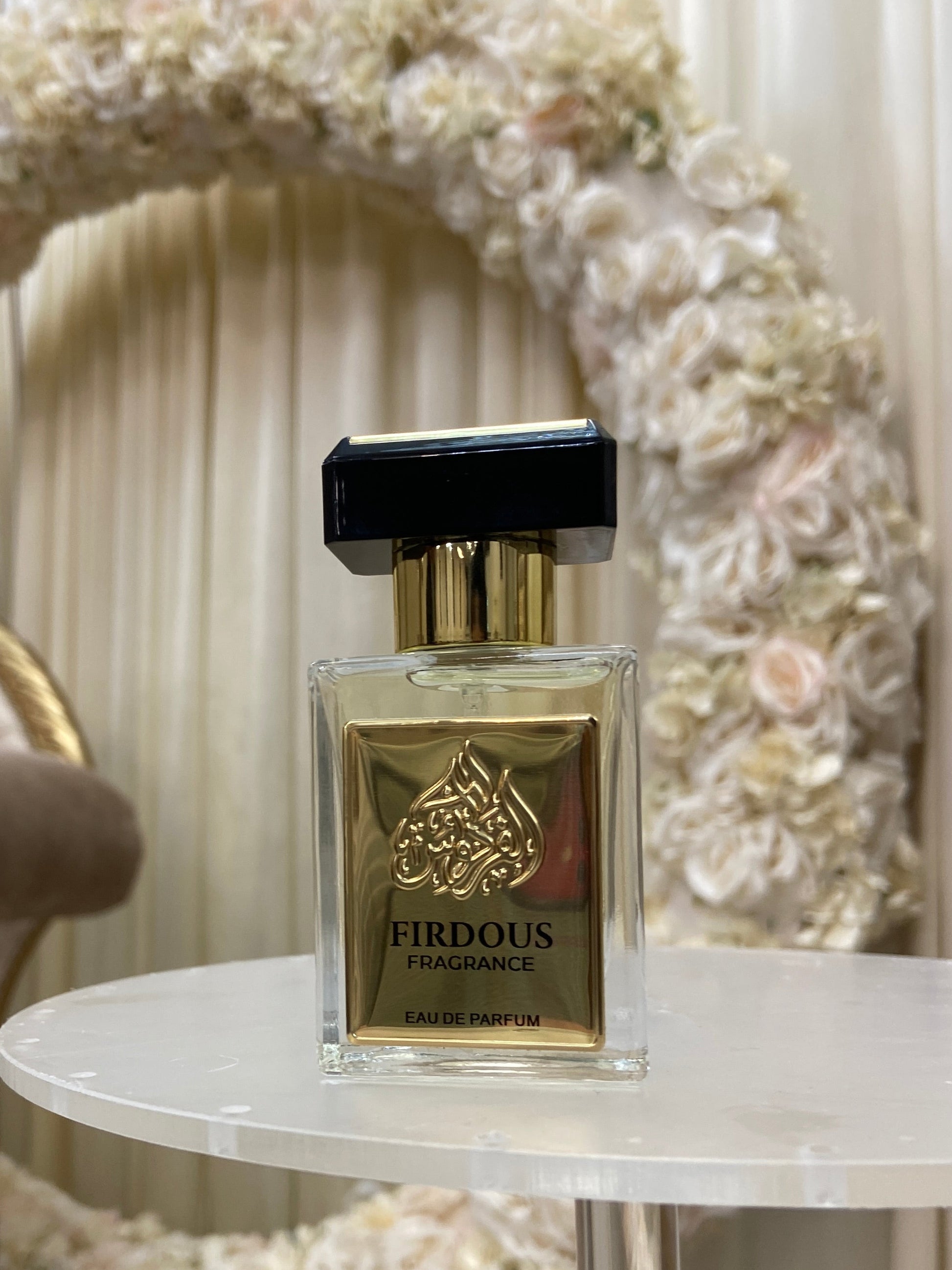 Perfume bottle on a decorative tray with floral design